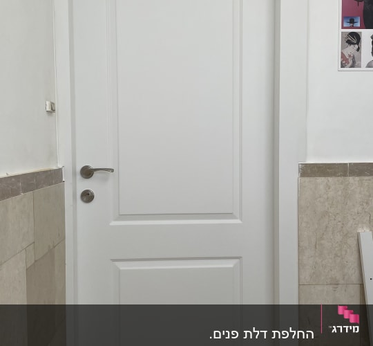 דלת לבנה עם ידית מתכת כסופה